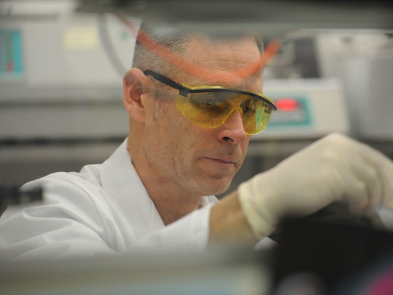Lab technician analyzing an organic fertilizer batch sample for nutrient content before commercial release