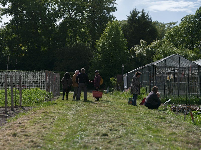 Grounds crew reviewing a four-season crop rotation plan during an organic vegetable gardening course practicum